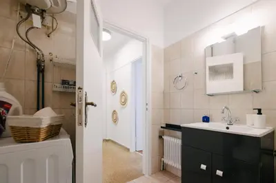 a bathroom with a sink and a toilet and a door at ZEN Sofokleous in psiri in Athens
