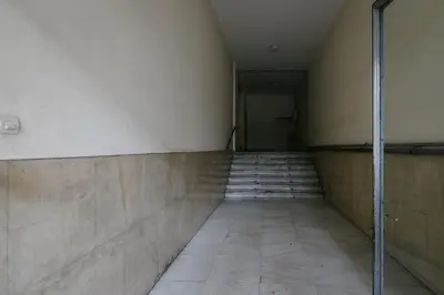 a hallway of an empty room with a tile floor at ZEN Sofokleous in psiri in Athens