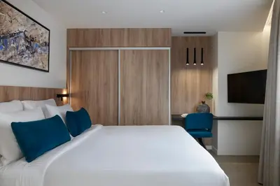 a hotel room with a large bed and a tv at Hestia - Kolokotroni 23 in Athens