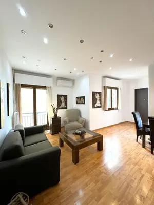 a living room with a couch and a table at An Athenian Gem by the Acropolis in Athens