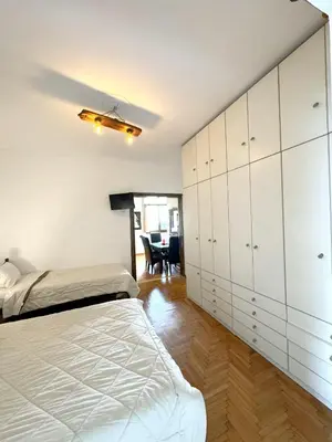a bedroom with a bed and a dining room at An Athenian Gem by the Acropolis in Athens