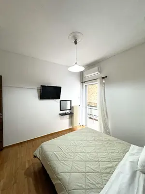 a bedroom with a large bed and a window at An Athenian Gem by the Acropolis in Athens