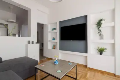 a living room with a couch and a tv at The Acropolis dream house in Athens