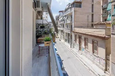 a balcony with a table and chairs on a building at The Acropolis dream house in Athens