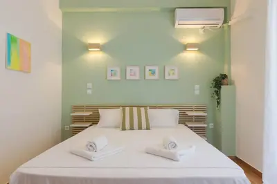 a bedroom with a large white bed with two towels at The Acropolis dream house in Athens