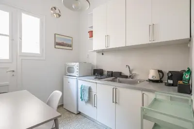a white kitchen with a sink and a microwave at Zen Exaricha in Athens