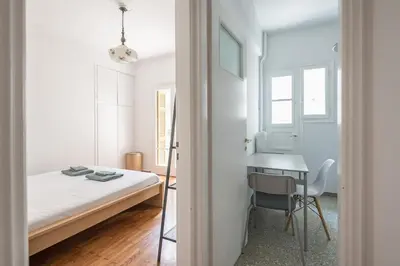 a small bedroom with a bed and a desk at Zen Exaricha in Athens