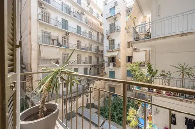 a balcony with a potted plant and buildings at Zen Exaricha in Athens