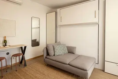 a living room with a couch and a table at Rooftops of Athens - Areos Studio Jacuzzi & View in Athens