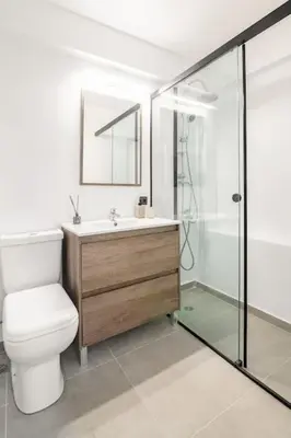 a bathroom with a toilet and a sink and a shower at VARKIZA APARTMENT in Varkiza