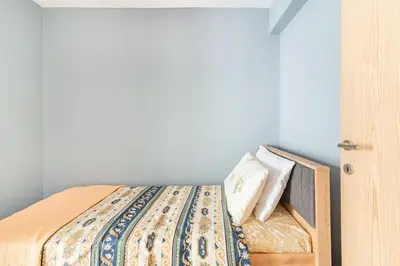 a bed with two pillows on it in a room at VARKIZA APARTMENT in Varkiza