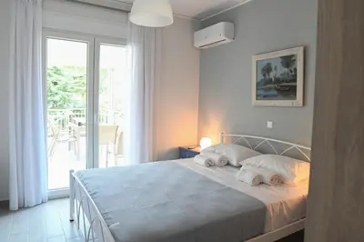 a bedroom with a bed with two towels on it at Αθηναϊκή Ριβιέρα in Anavissos