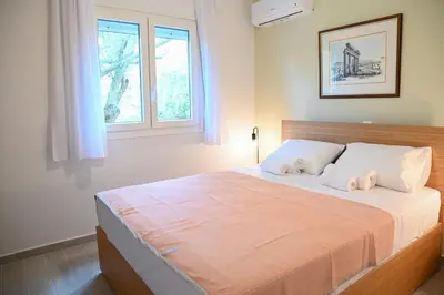 a bedroom with a large bed with towels on it at Αθηναϊκή Ριβιέρα in Anavissos