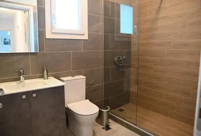a bathroom with a toilet and a sink and a shower at Αθηναϊκή Ριβιέρα in Anavissos