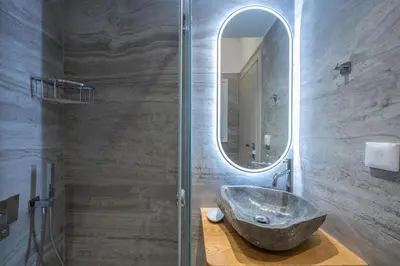 a bathroom with a sink and a mirror at Newly Renovated Escape/Psychiko in Athens