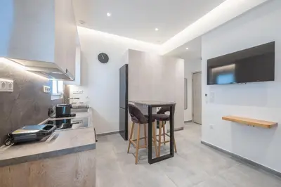 a kitchen with a counter with a bar stool in it at Newly Renovated Escape/Psychiko in Athens