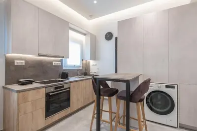 a kitchen with a table and two bar stools at Newly Renovated Escape/Psychiko in Athens