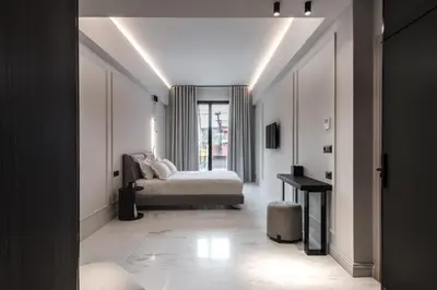 a bedroom with a bed and a table in a room at Maison7 - Acropolis in Athens