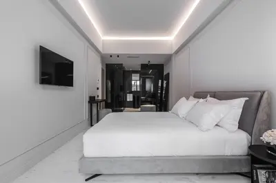 a bedroom with a white bed and a couch at Maison7 - Acropolis in Athens