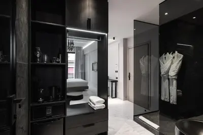 a black and white bathroom with a mirror at Maison7 - Acropolis in Athens