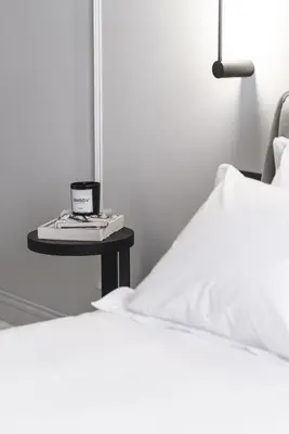 a bed and a table with a candle on a bed at Maison7 - Acropolis in Athens