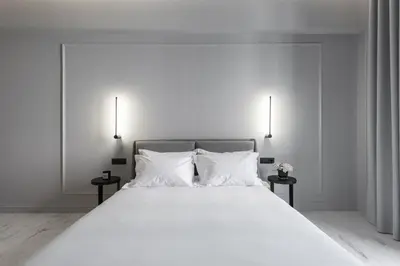 a bedroom with a large white bed with two night stands at Maison7 - Acropolis in Athens