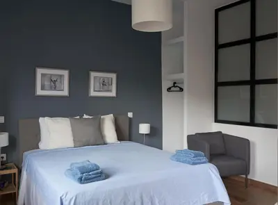 a bedroom with a bed with blue towels on it at The sunny house in Athens