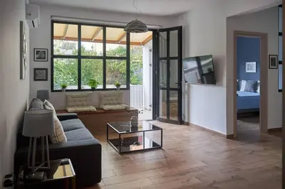 a living room with a couch and a glass table at The sunny house in Athens