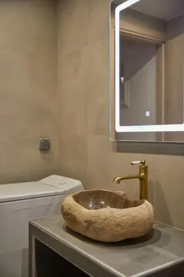 a bathroom with a sink with a toilet and a mirror at The sunny house in Athens