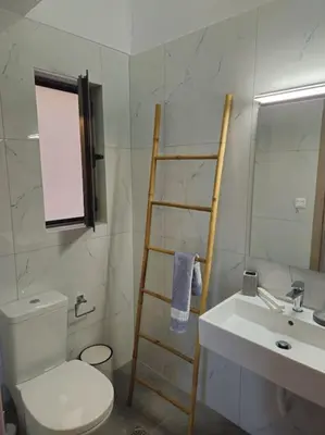 a bathroom with a white toilet and a sink at Cozy & Minimal Apartment Near Airport Peania in Paianía