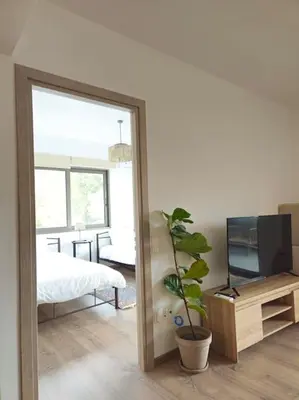 a mirror in a room with a bed and a television at Cozy & Minimal Apartment Near Airport Peania in Paianía