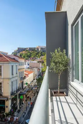 a view from the balcony of a building with a tree at Nsplace in Athens