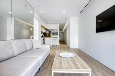 a living room with a white couch and a table at Nsplace in Athens