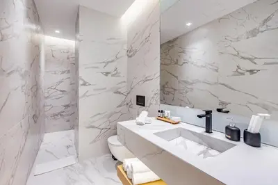 a white bathroom with a sink and a toilet at Nsplace in Athens