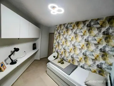 a small room with a bed and a wall at Floral Home 1 - ground floor apt, private parking! in Athens