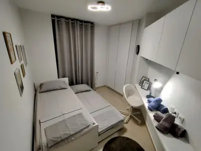 a small room with two beds and a desk at Floral Home 1 - ground floor apt, private parking! in Athens