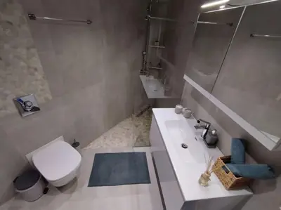 a bathroom with a toilet and a sink and a shower at Floral Home 1 - ground floor apt, private parking! in Athens