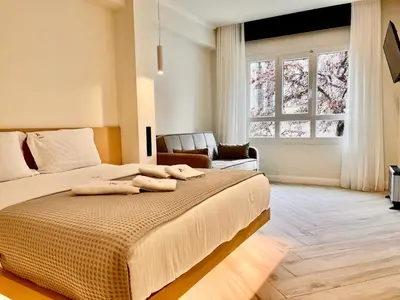 a bedroom with a bed with two towels on it at Triple A - Stylish Seven On The Pedestrian - FREE Parking! in Athens