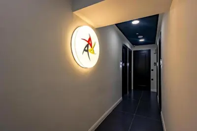 a hallway with a clock on the wall at Triple A - Stylish Seven On The Pedestrian - FREE Parking! in Athens