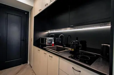 a black kitchen with a sink and a stove at Triple A - Stylish Seven On The Pedestrian - FREE Parking! in Athens