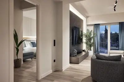 a living room with a bed and a couch and a mirror at Acropolis Grand Suite in Athens