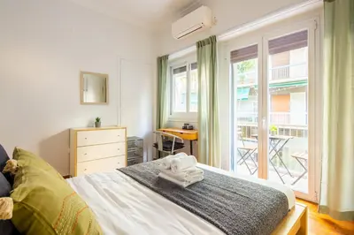 a bedroom with a bed and a large window at Socrates 1-Bedroom Apartment in Athens in Athens