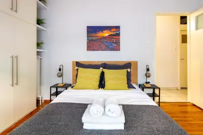 a bedroom with a bed with two towels on it at Socrates 1-Bedroom Apartment in Athens in Athens