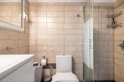 a bathroom with a toilet and a glass shower at Socrates 1-Bedroom Apartment in Athens in Athens