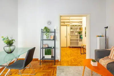 a living room with a glass table and a couch at Socrates 1-Bedroom Apartment in Athens in Athens