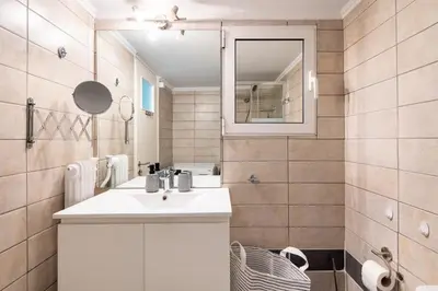 a bathroom with a white sink and a mirror at Socrates 1-Bedroom Apartment in Athens in Athens