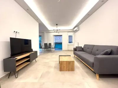 a living room with a couch and a flat screen tv at 2-Bed Gem in Serene Locale in Athens