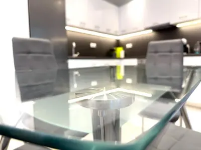 a glass table and chairs in a room at 2-Bed Gem in Serene Locale in Athens