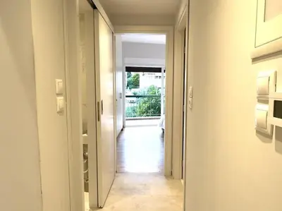 a hallway with a door leading into a room at 2-Bed Gem in Serene Locale in Athens