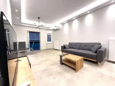 a living room with a couch and a coffee table at 2-Bed Gem in Serene Locale in Athens